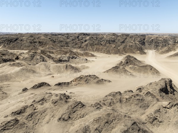 Aerial view, dry barren mountains in Moon Valley, rocky landscape ridged by erosion, Namib-Naukluft