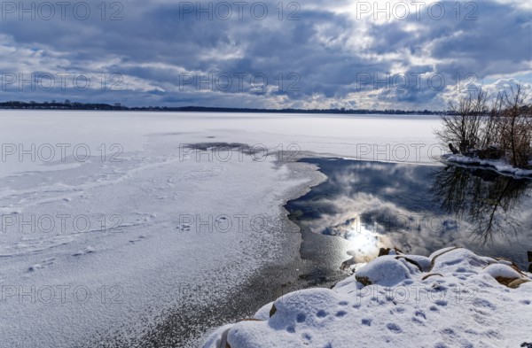 View of Schaalsee, covered with ice and snow, on the bridge tour, a hiking trail around Lake