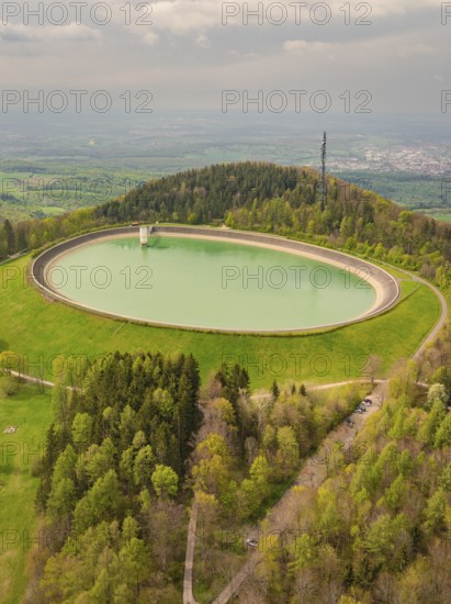 Upper reservoir, view of a water reservoir surrounded by green landscape and forest, Glems