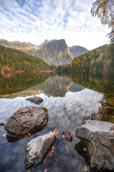 Mountain peaks of the Ötztal Alps reflected in Lake Piburger See, in autumn, near Ötz in Ötztal,