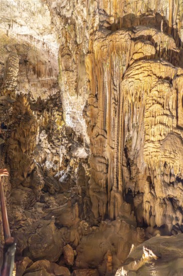 Tourists marvel at the stunning stalactites and stalagmites formations inside postojna cave, a
