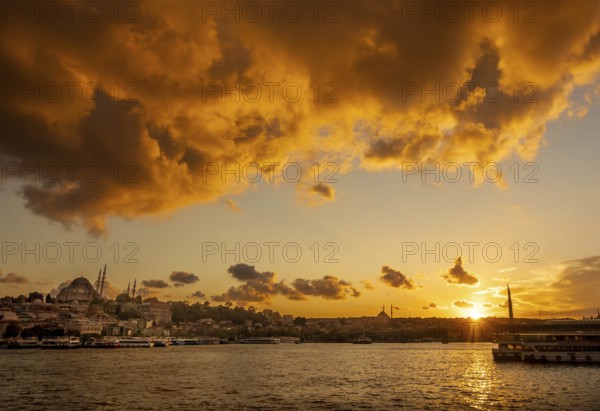A vibrant sunset illuminates the sky above Istanbul, highlighting the silhouettes of mosques and a