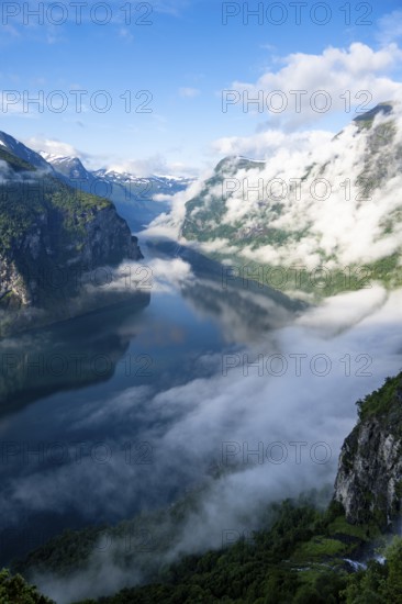 Atmospheric clouds over the fjord in the morning light, view of Geirangerfjord, at Ørnesvingen
