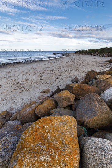 Coastal defence, boulders with view on sandy beach, dusk, Carne Beach, Wexford, Gerrans Bay,