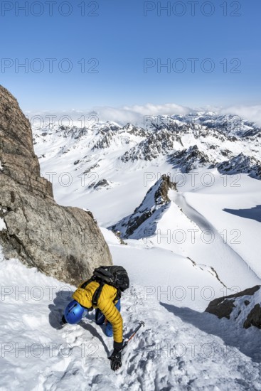 Mountaineer with ice axe and crampons, ascent through steep snowfield to Piz Kesch or Piz d'Es-cha
