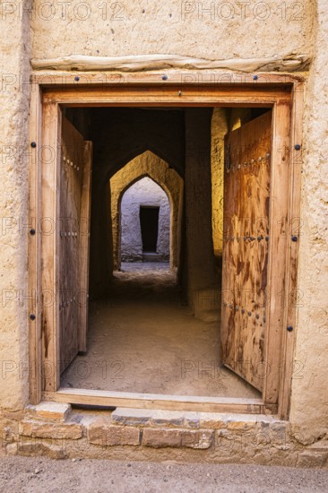 View through an entrance door in the largest preserved mud town in Oman, Al Bilaad, Al Bilaad