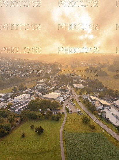 Wide panoramic view of a village at sunrise with green surroundings, Gechingen, Black Forest,