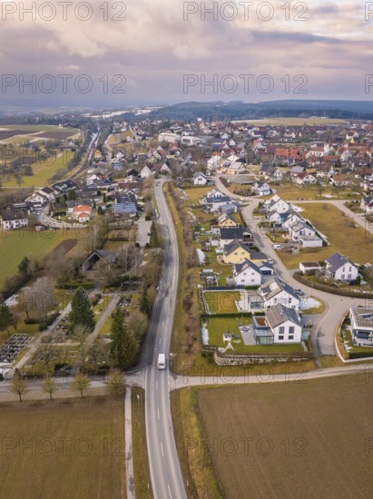 Aerial view of a rural suburb with streets and houses next to open fields, Schopfloch, Freudenstadt