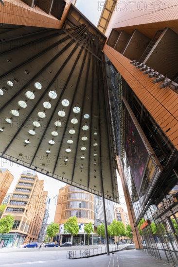 Tall, modern buildings with glass facades and geometric shapes that offer a broad urban