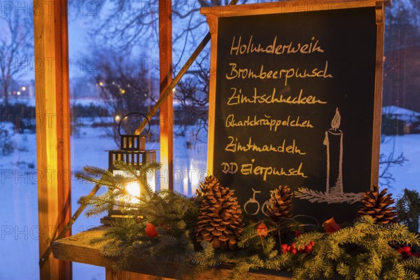 Christmas decoration, still life in a winter garden with blackboard with lettering such as