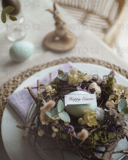 Top view of an elegantly arranged Easter table setting featuring naturally dyed eggs nestled in a