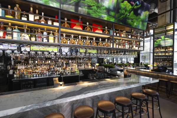 Fort Lauderdale restaurant bar with a variety of wine and liquor bottles and glasses on the shelves