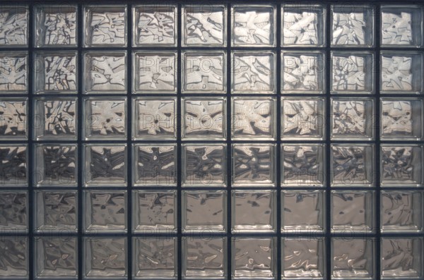 Aesthetic and modern design of textured glass block wall, capturing abstract patterns and light