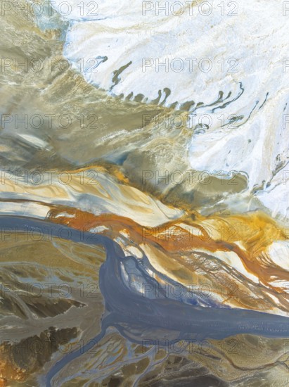 Top view aerial shot capturing the enticing swirls and organic patterns formed by natural elements.
