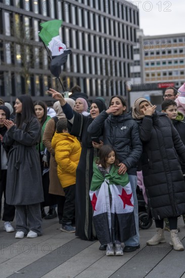 Syrian woman celebrate the end of the Assad regime after the change of power in Syria at a rally on
