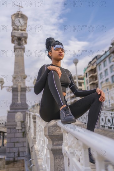Beautiful Dominican Ethnic Girl with with braids with full body suit. Fashion, sitting on the beach