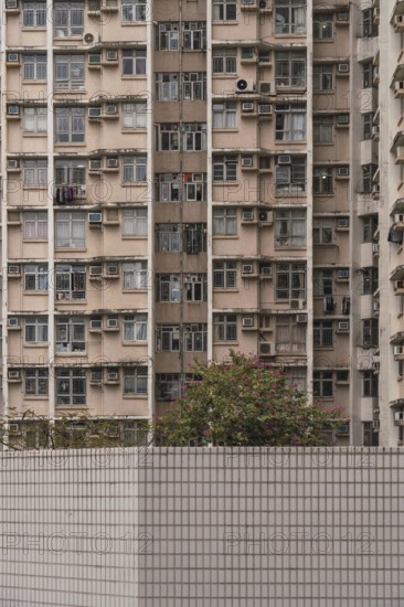 A close-up view of a densely packed residential building in Hong Kong, illustrating urban living