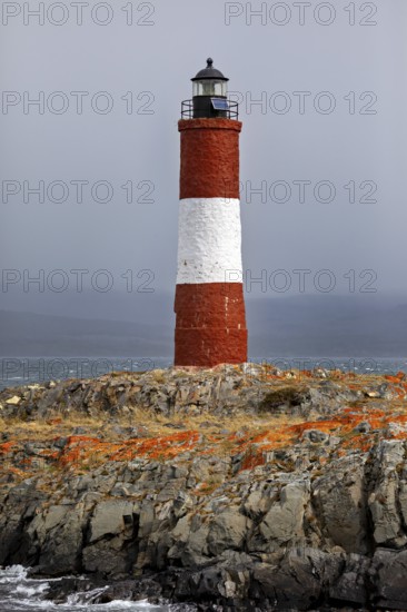 Lighthouse on rocky terrain under a cloudy sky, The lighthouse in the Beagle Channel near Ushuaia