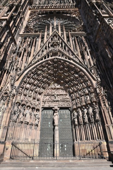 Strasbourg, France, September 2023: Gothic style entrance door with tympanum of west facade of