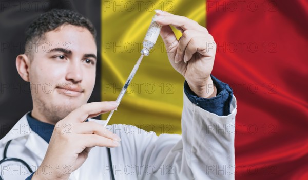 Doctor holding syringe on Belgium flag background. Medical professional holding syringe with
