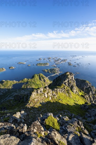View of numerous small rocky islands with houses, at the summit of Festvågtind, view of