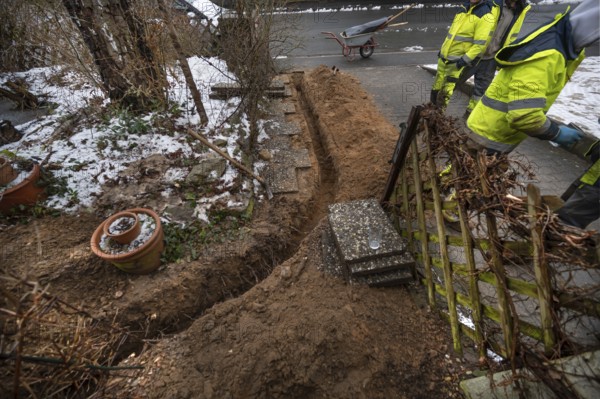 Excavation to lay Telekom's fiber optic cables in a residential building, Eckental, Middle