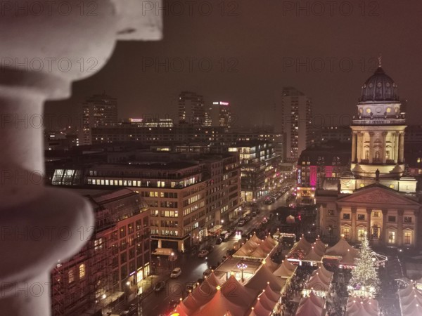 Night view over the roofs of the Christmas market on the Gendarmenmarkt of the festively