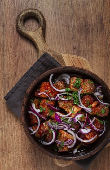 Fried meat, pork kebab, ketsi in a clay pan, with red onions and herbs, homemade, no people