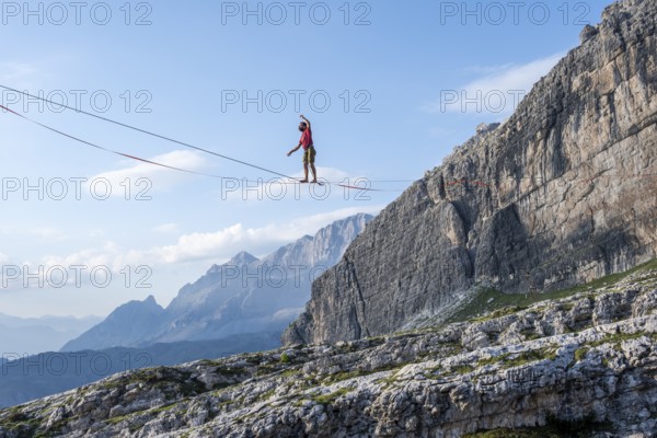 Slackliner in the mountains, mountain peaks of the Brenta Mountains, at Refugio Francis Fox