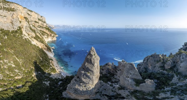 Picturesque rocky coast, cliffs with L'Aguglia pinnacle, blue sea and Cala Goloritzé beach, aerial