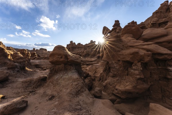 Goblin Valley State Park in Utah features unique rock formations glowing under the sun's rays. The