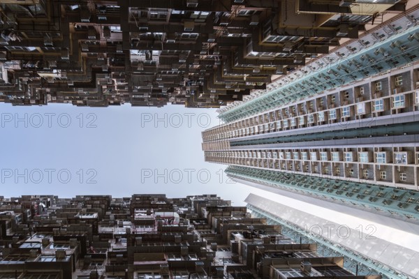 Low angle of a striking vertical view of dense residential towers in Hong Kong, showcasing the