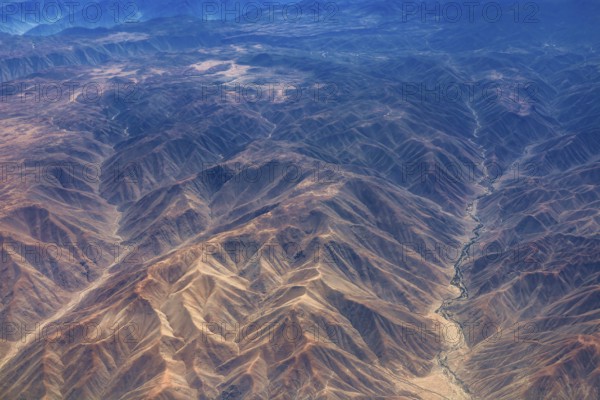 Breathtaking mountain formations in an arid desert region seen from the air, the landscape and