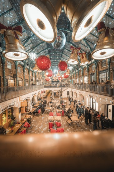 View of a decorated shopping mall with big golden bells and red balls on the ceiling, AppleMarket,
