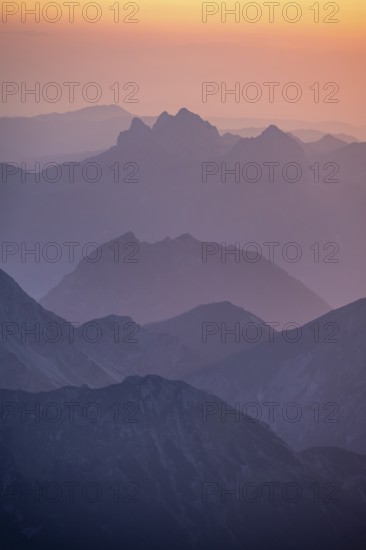 Silhouettes of mountains at sunset, view from the summit of the Zugspitze, Wetterstein Mountains,