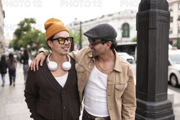 A joyful colombian gay couple enjoying a casual city walk. Both are wearing sunglasses and