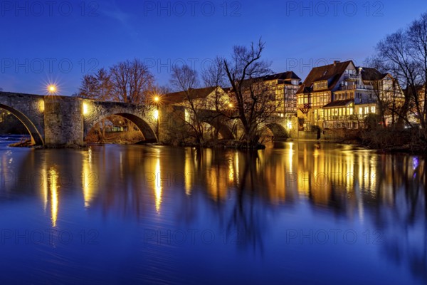 Illuminated bridge reflected in the blue water at night, peaceful atmosphere, The historic