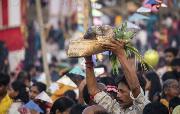 Hindu devotees gather on the banks of the Brahmaputra River to offer prayers to the Sun God on the