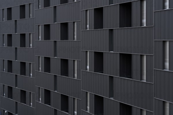 Modern building featuring a distinct, sustainable architectural style with vertically aligned,