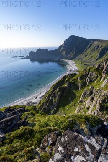 View of coastal landscape, cliffs with peak Måtind or Måtinden, Høyvika beach and sea, hike to the
