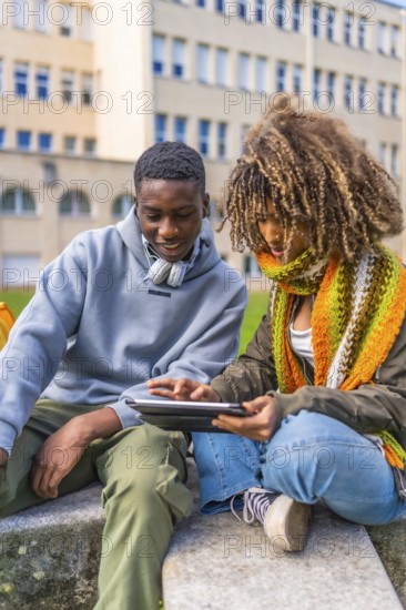 Millennial diverse student friends studying for an exam using digital tablet before going into
