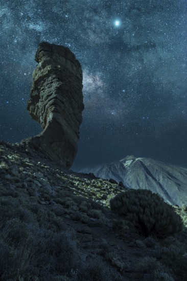 Milky way on the Roque Cinchado next to Teide in the natural park of Tenerife, Canary Islands.