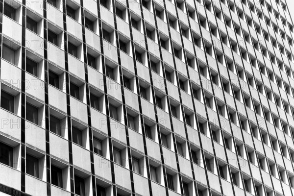 Black and white image of a building facade with repetitive square windows in Sidney, Australia.