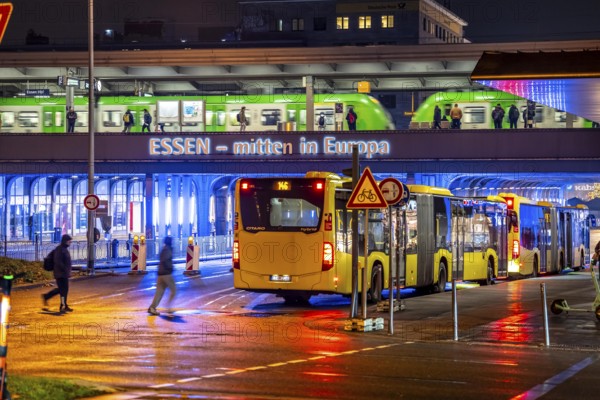The main train station in Essen, blue illuminated underpass, bus station, am Europaplatz, train on