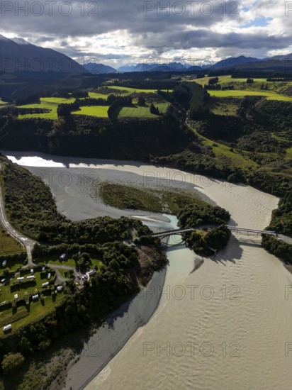 Aerial view captures the diverse landscape of Canterbury, New Zealand, highlighting winding rivers,