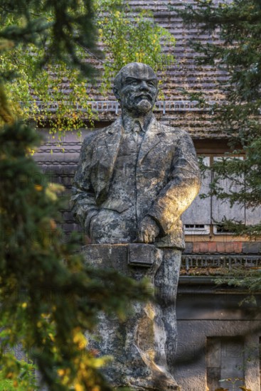 Statue of Vladimir Ilyich Lenin in front of the ruins of the Officers' House, officers' mess at the
