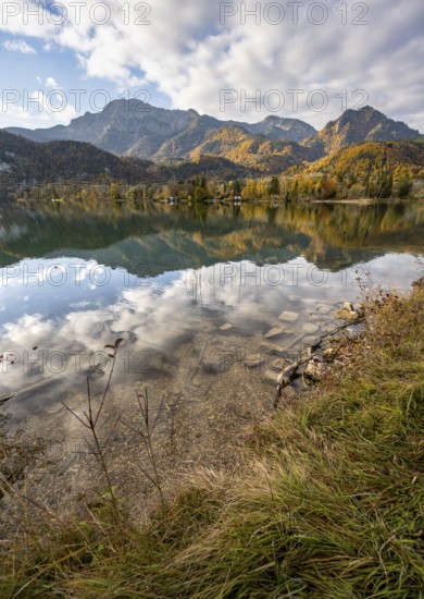 On the shore of Lake Lake Kochel with reflection, autumn landscape with mountain peaks Herzogstand
