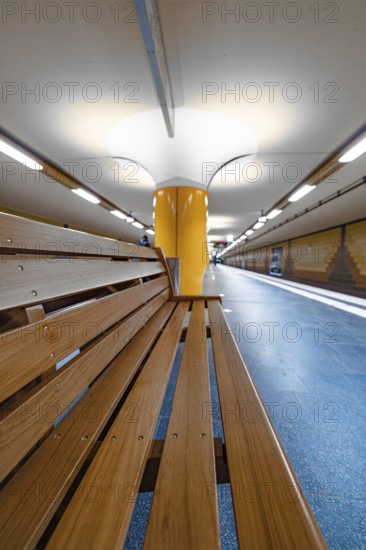 Modern underground station with yellow columns and bright lighting, Hamburg, Germany