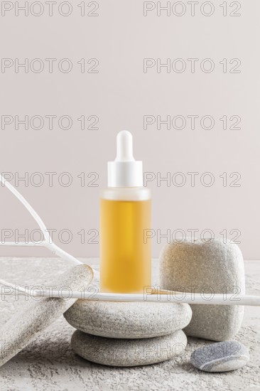 A luxury skincare oil bottle with a dropper, nestled among smooth stones Minimalist aesthetic with