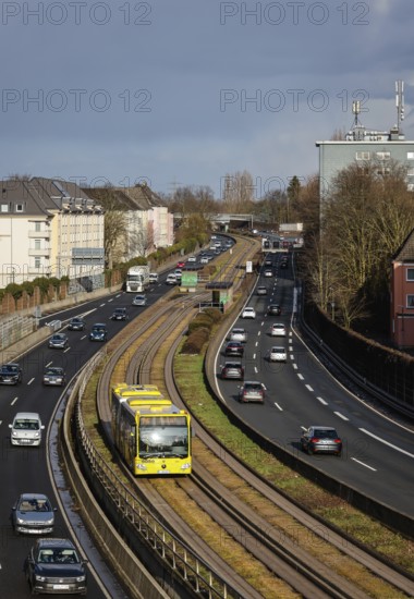 Essen, North Rhine-Westphalia, Germany - Cars and a public bus drive through Essen city centre on